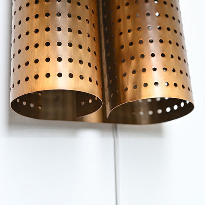 Honeycomb shadowed hollowing rolled steel sconce